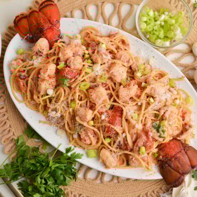 overhead shot of platter of lobster cream sauce pasta