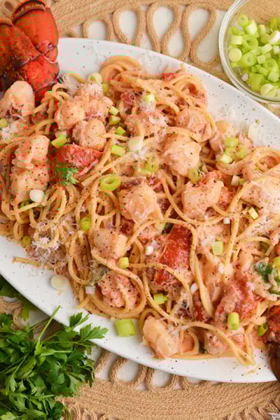 overhead shot of platter of lobster cream sauce pasta