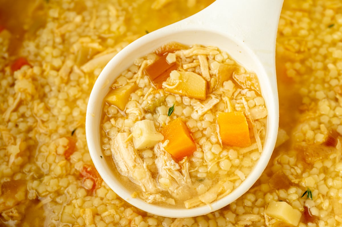 close up shot of ladle in pot of italian pastina soup