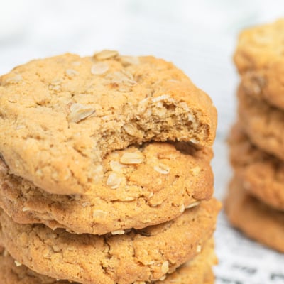 stack of peanut butter oatmeal cookies with bite taken out of top one