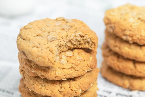 stack of peanut butter oatmeal cookies with bite taken out of top one