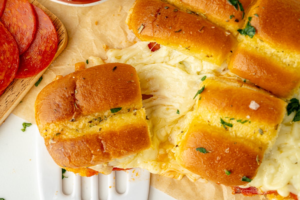 overhead shot of cheesy slider separating from bunch