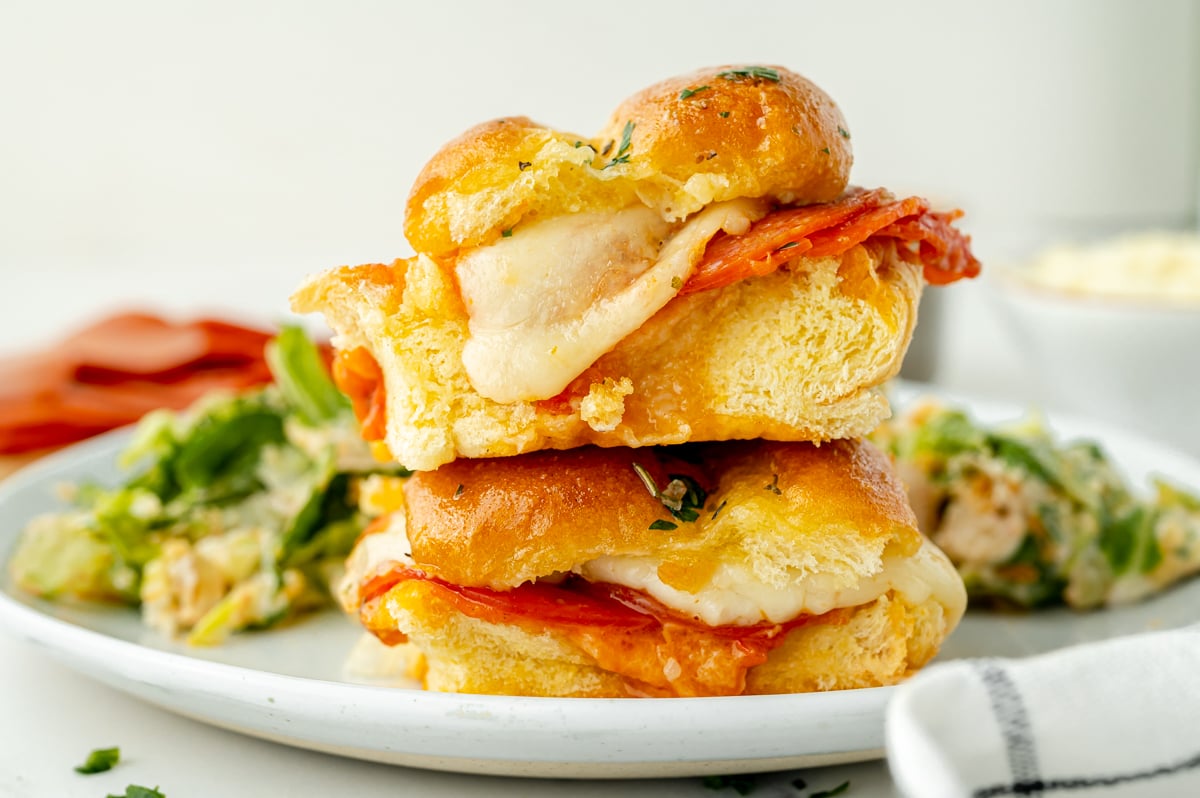 straight on shot of stack of two pizza sliders on plate
