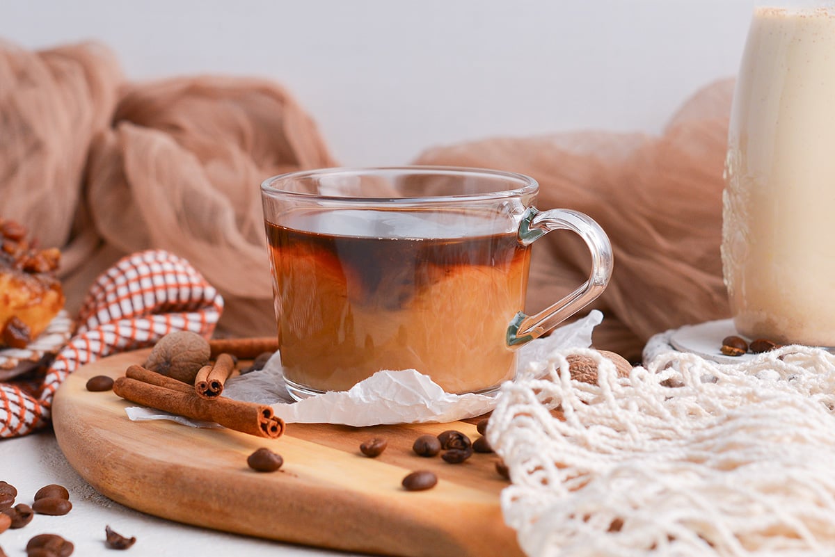 creamer added to cup of coffee