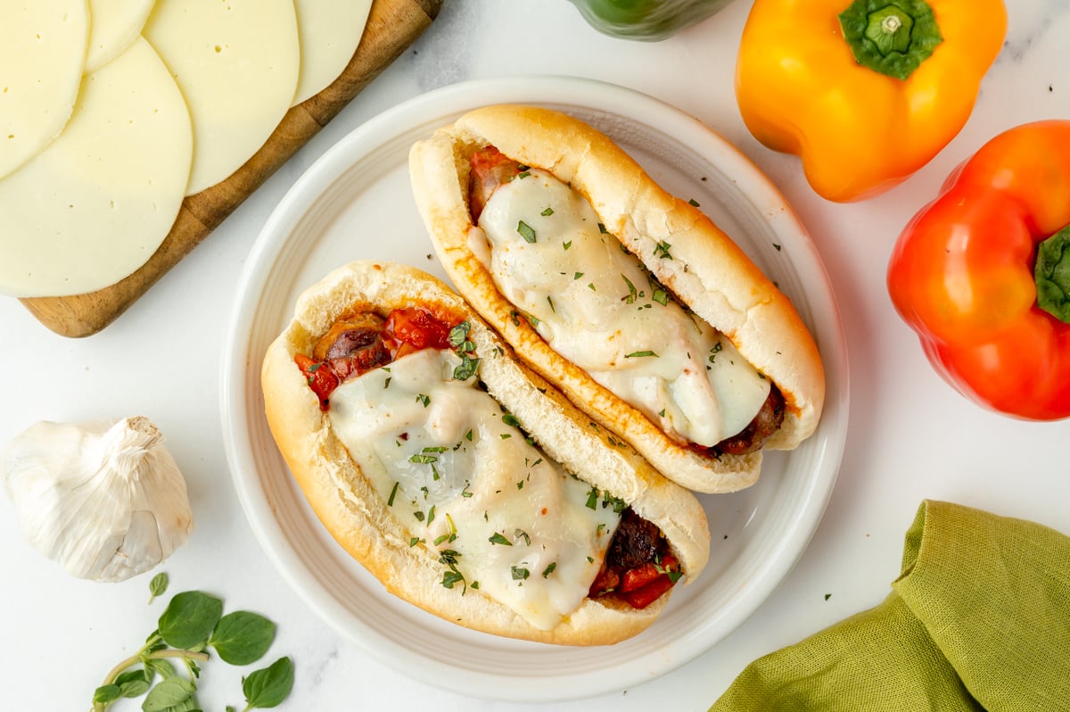 overhead shot of two italian sausage sandwiches on plate