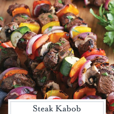 angled shot of kabobs marinated in steak kabob marinade on board with text overlay