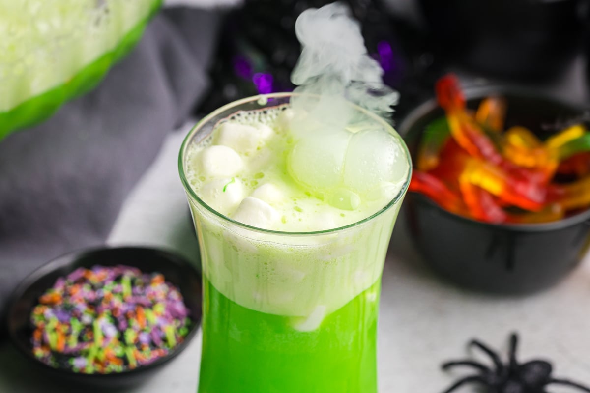 close up angled shot of witches brew topped with marshmallows in cup