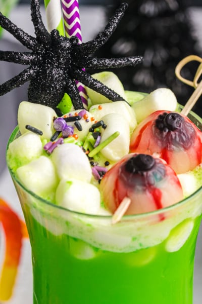 close up of marshmallows and gummies in cup of witches brew