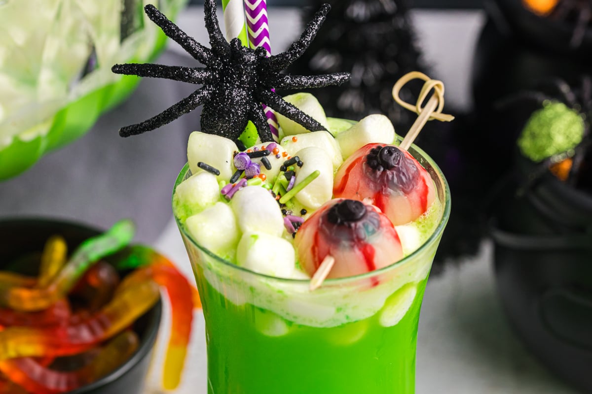 close up of marshmallows and gummies in cup of witches brew