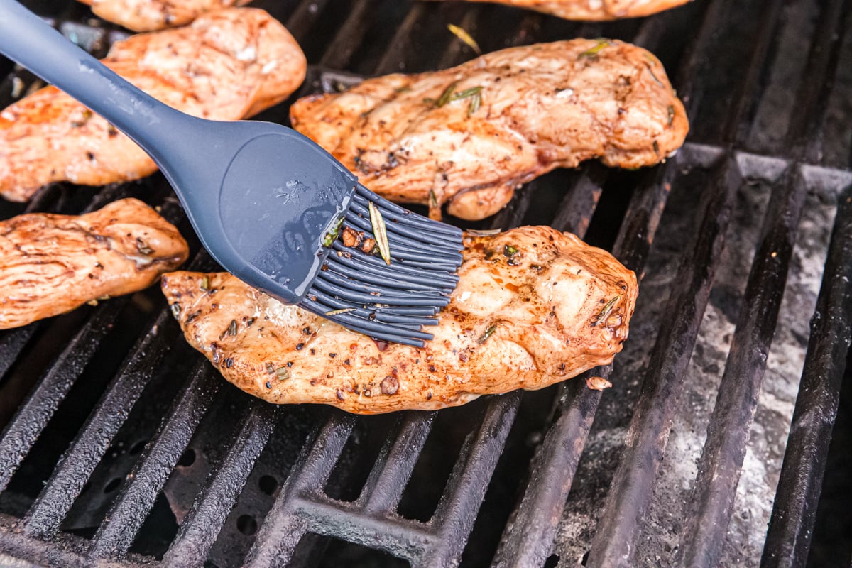 balsamic chicken marinade brushed onto chicken on grill