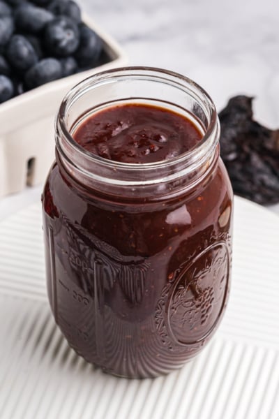angled shot of jar of cranberry bbq sauce
