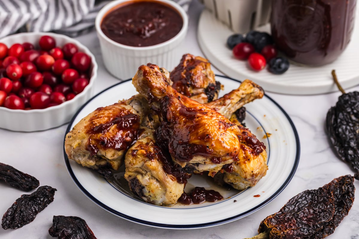 plate of chicken legs coated in bbq sauce