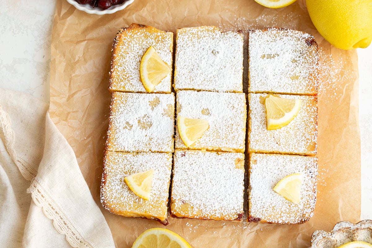 overhead shot of sliced cranberry lemon bars on parchment