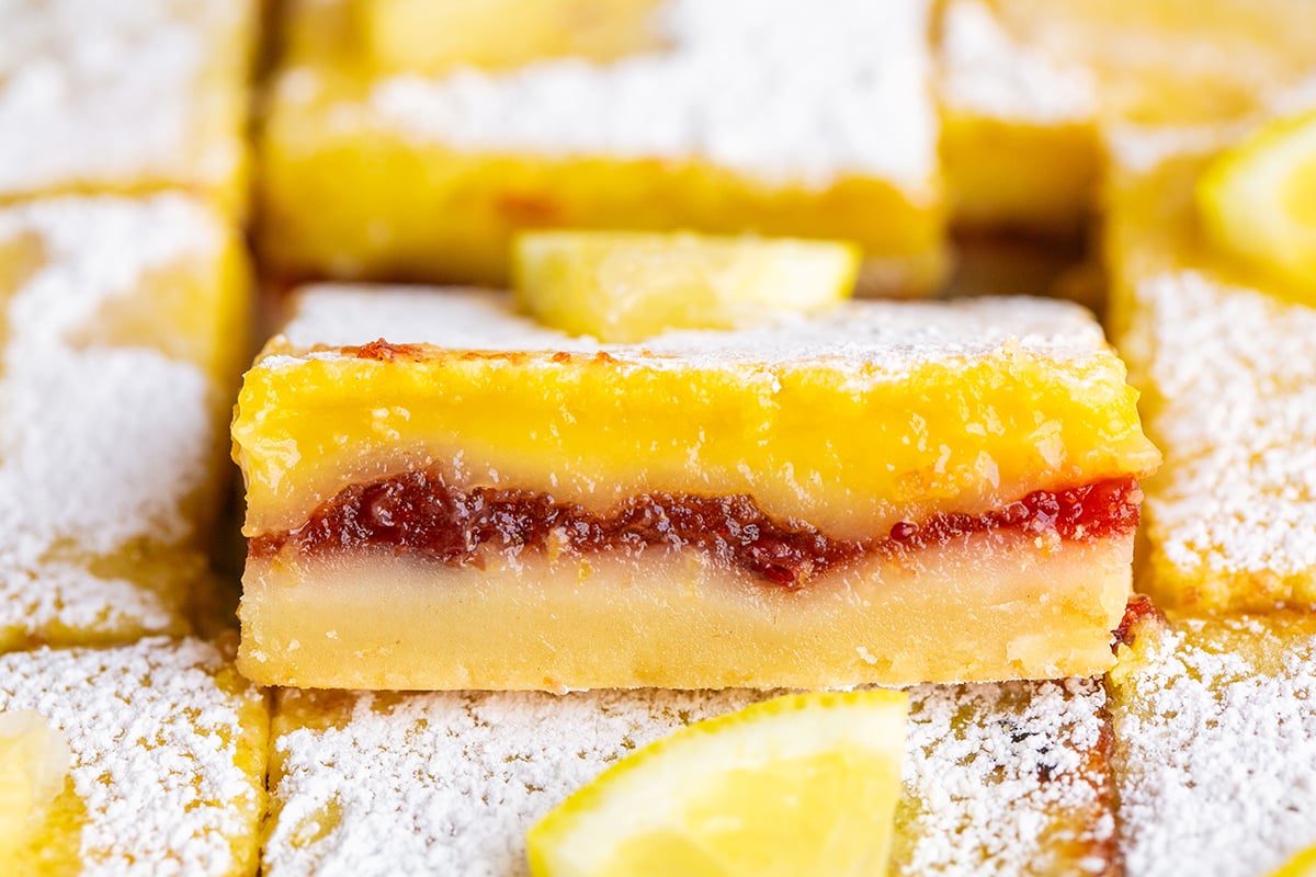 close up side view of lemon bar with cranberry