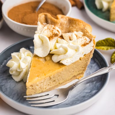 angled shot of slice of maple cream pie on plate with fork