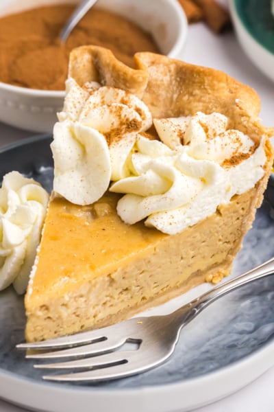 angled shot of slice of maple cream pie on plate with fork