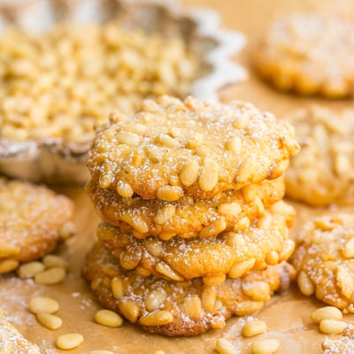 stack of pine nut cookies on parchment paper