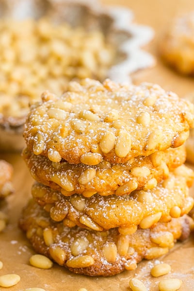 stack of pine nut cookies on parchment paper