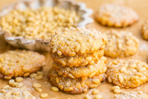 stack of pine nut cookies on parchment paper