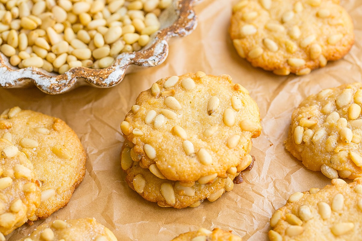 angled shot of stack of two pignoli cookies