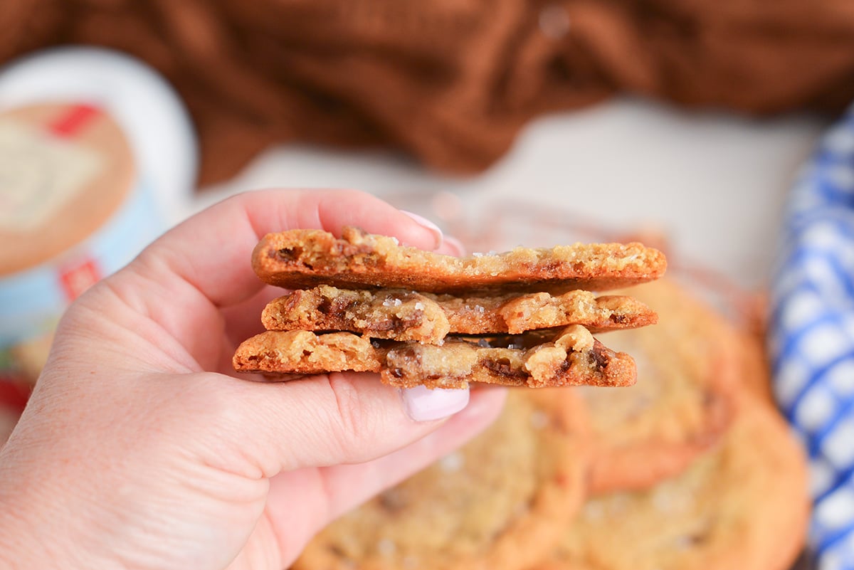 hand holding stack of broken in half rolo cookies
