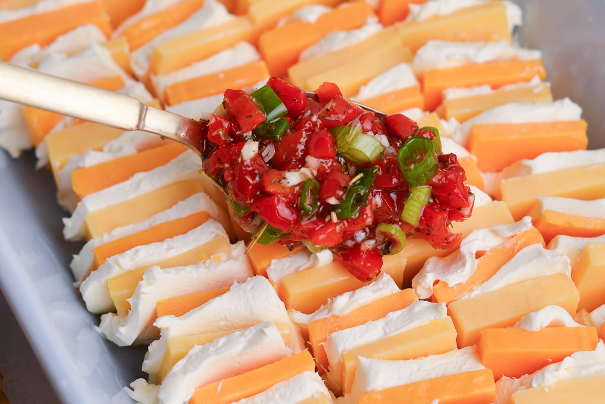 spoon adding marinade to cheese slices