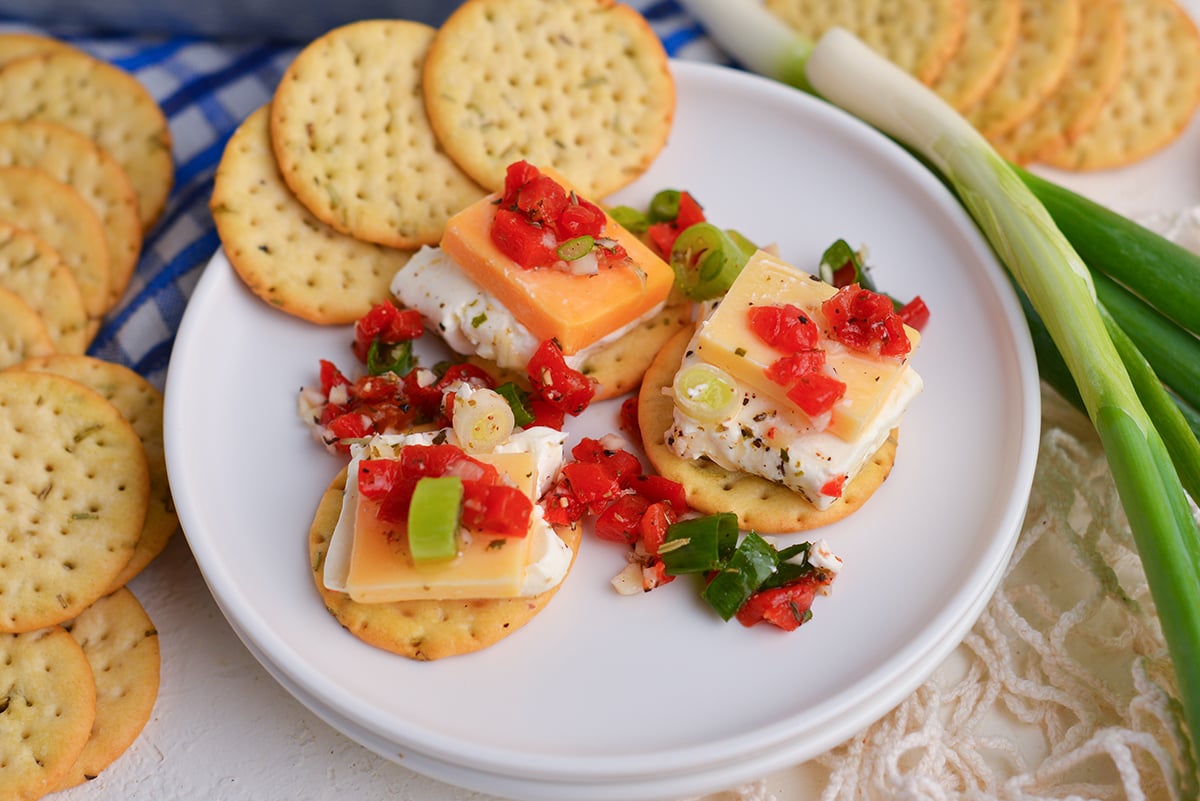 three crackers topped with marinated cheese