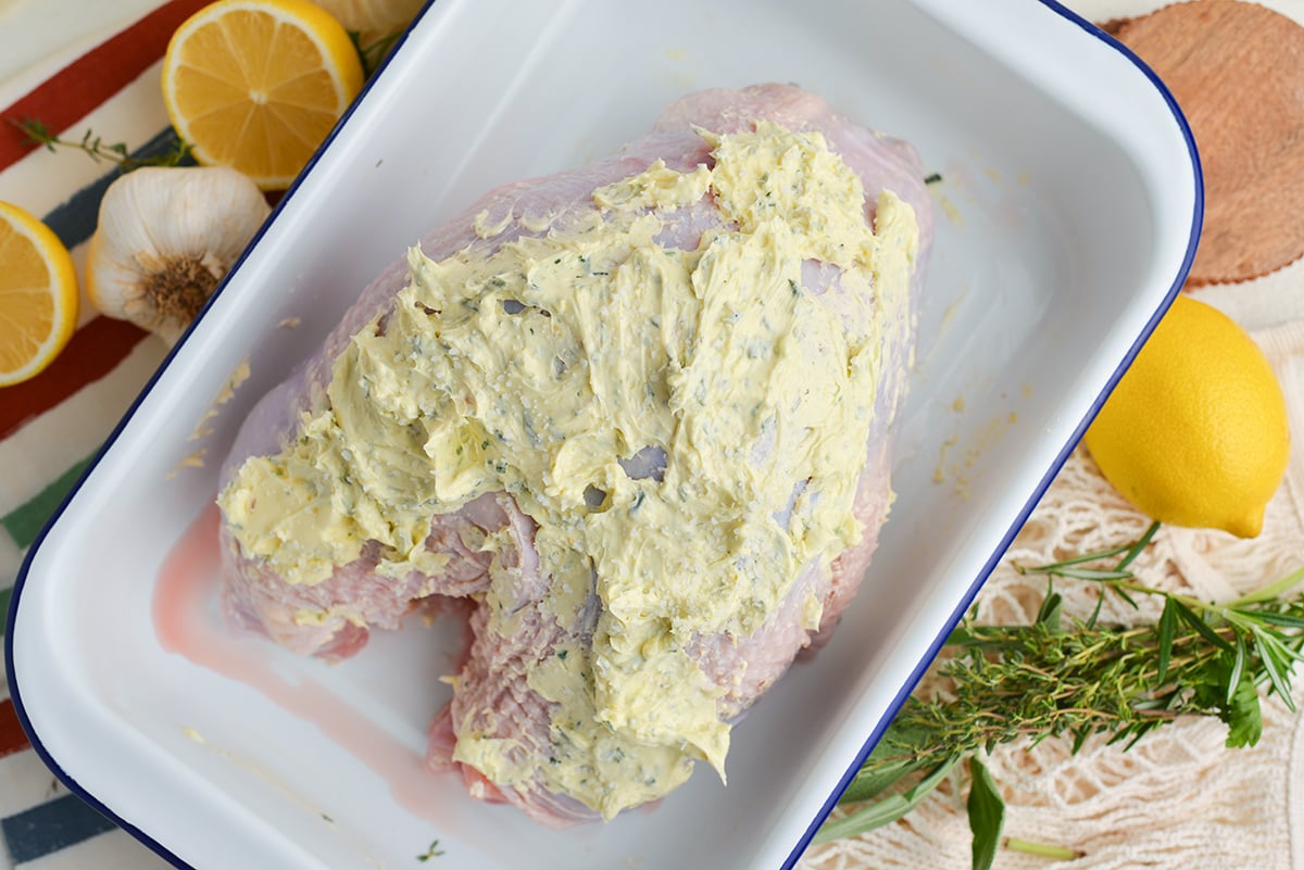 raw turkey coated in butter mixture