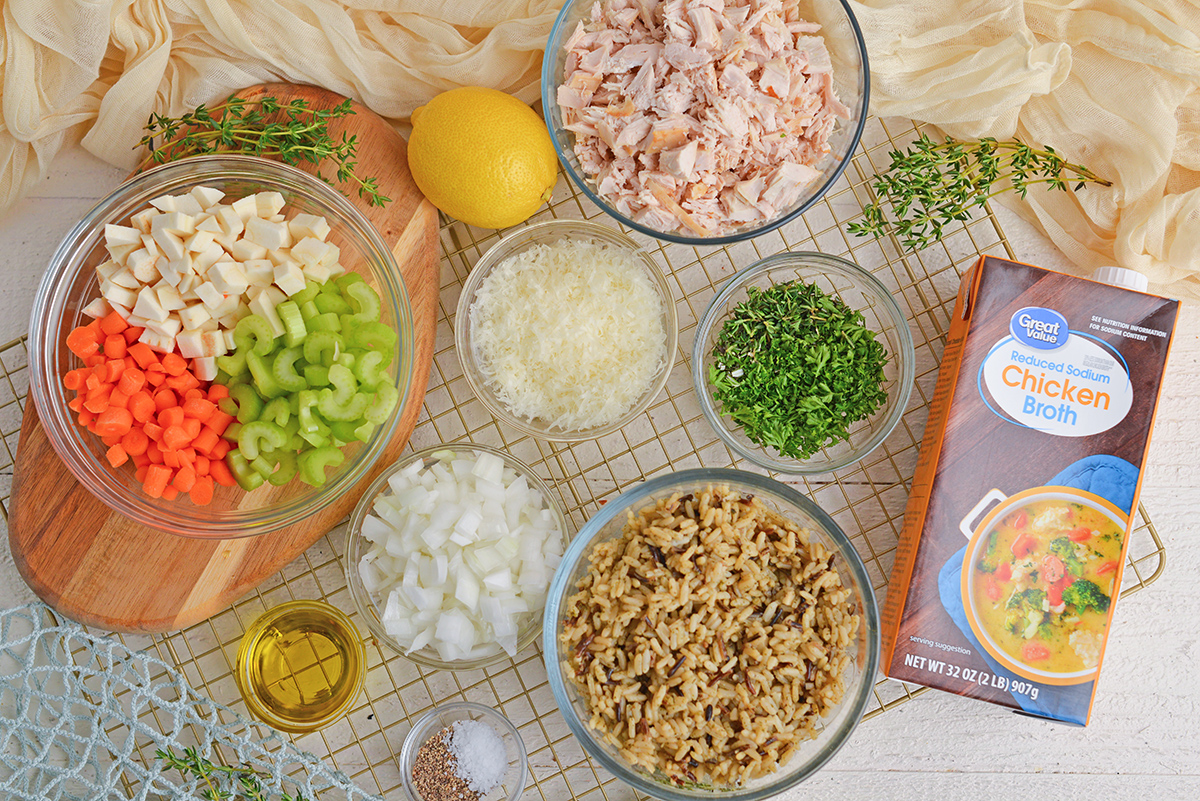 Ingredients for chicken and wild rice soup: carrots, parsnips, celery, onion, Parmesan, lemon, herbs.