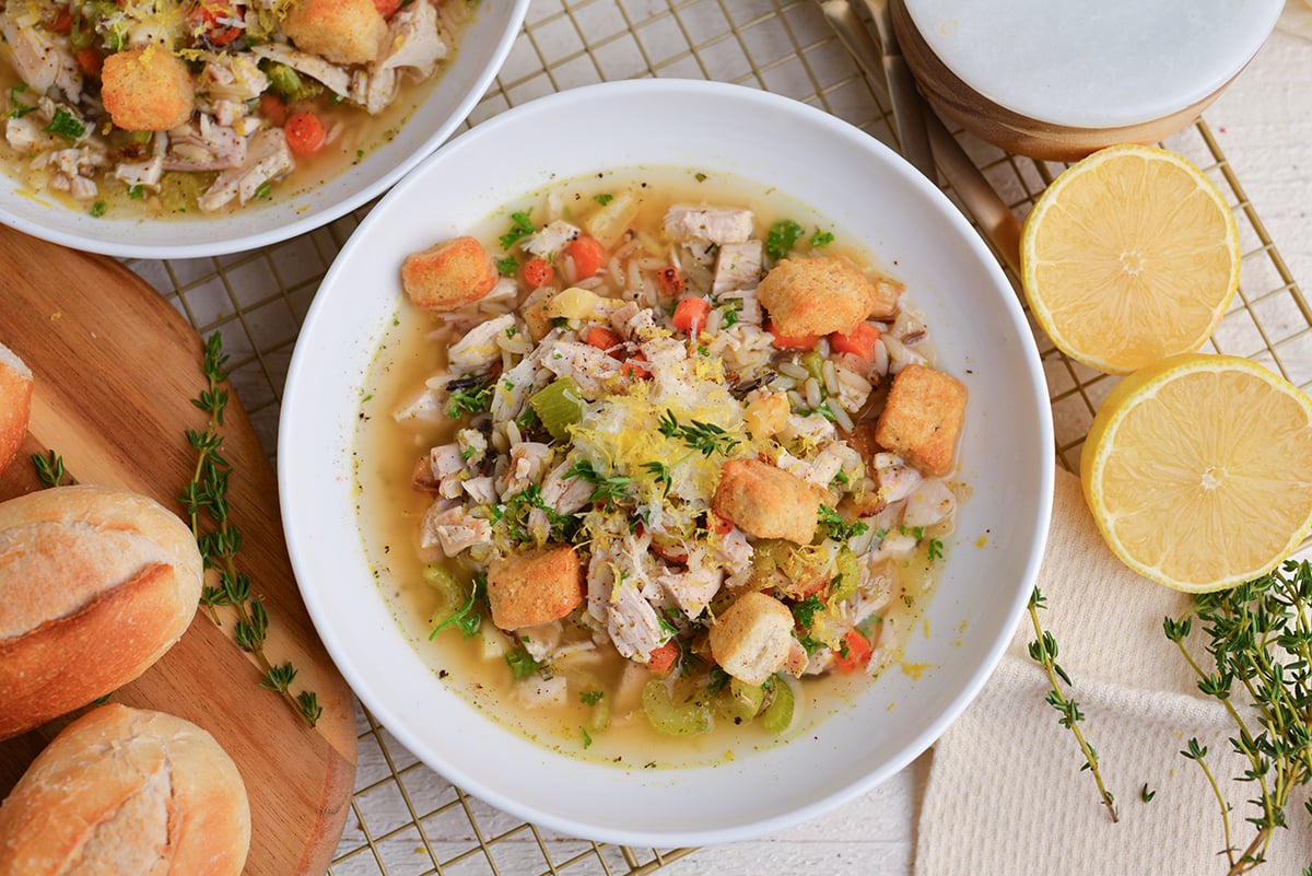Close-up of wild rice, shredded chicken, and sliced carrots in a silky lemon-Parmesan broth