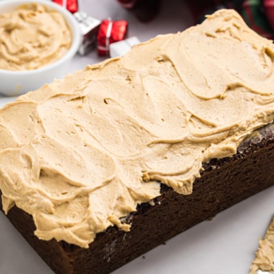 angled shot of gingerbread cream cheese frosting on loaf cake