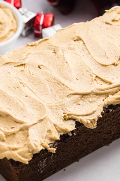 angled shot of gingerbread cream cheese frosting on loaf cake