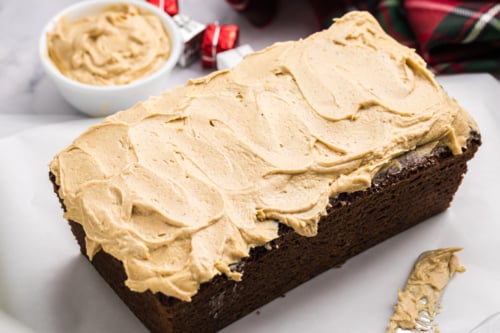 angled shot of gingerbread cream cheese frosting on loaf cake