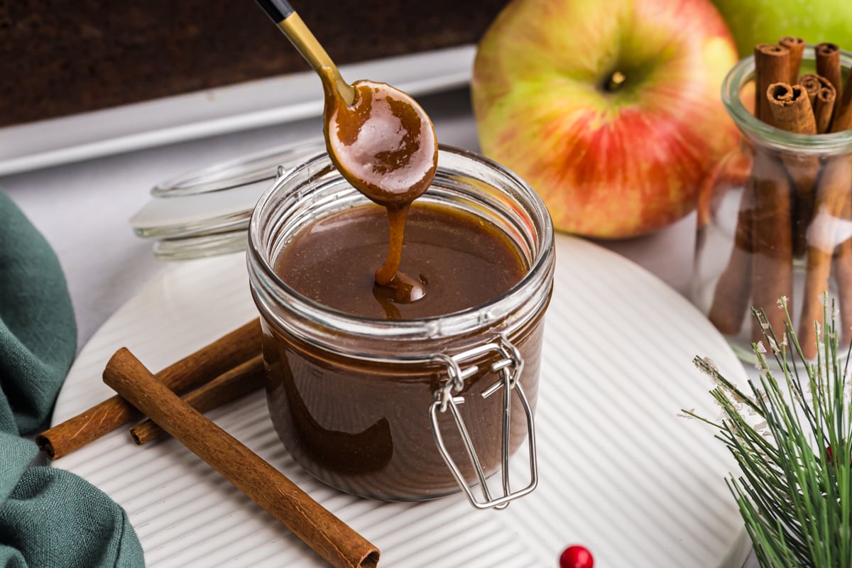 spoon dipping into jar of gingerbread caramel sauce
