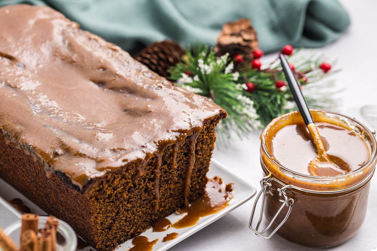 gingerbread loaf next to jar of gingerbread caramel sauce