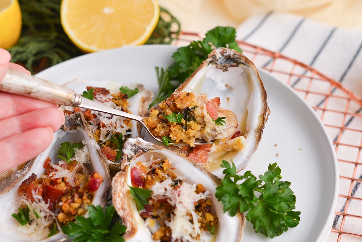 fork digging into oysters rockefeller