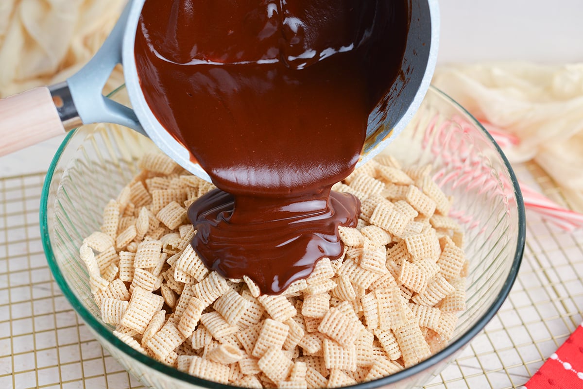 melted chocolate pouring into bowl of chex cereal