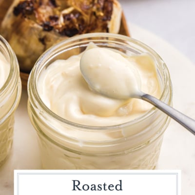 spoon in jar of garlic aioli with text overlay