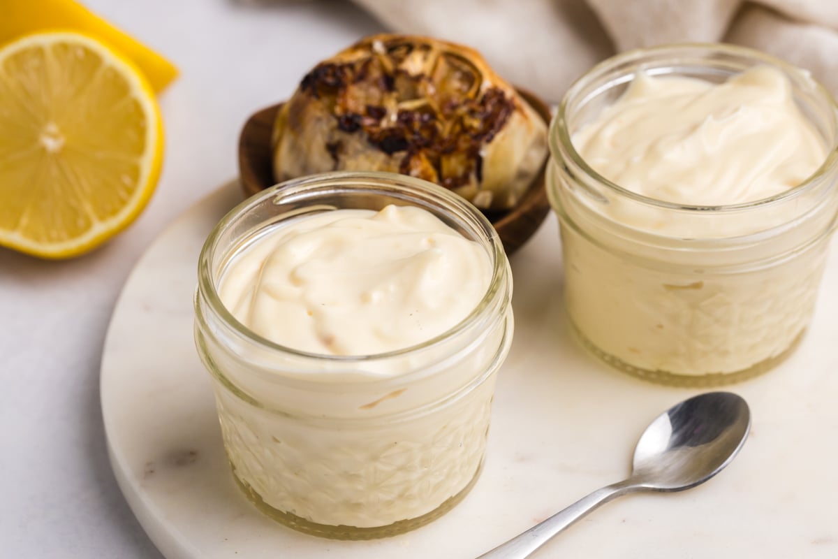 angled shot of two jars of garlic aioli