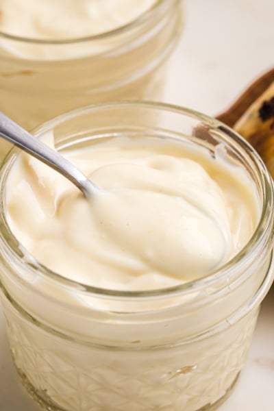 close up of spoon in jar of roasted garlic aioli