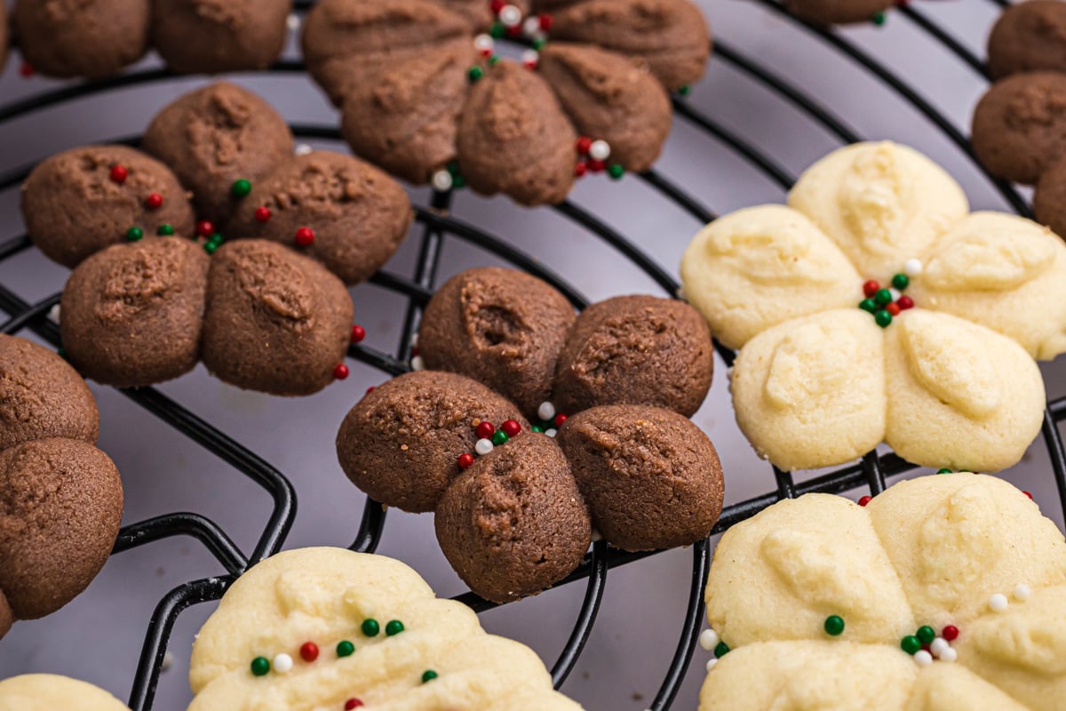 close up angled shot of chocolate and vanilla cookies on cooling rack