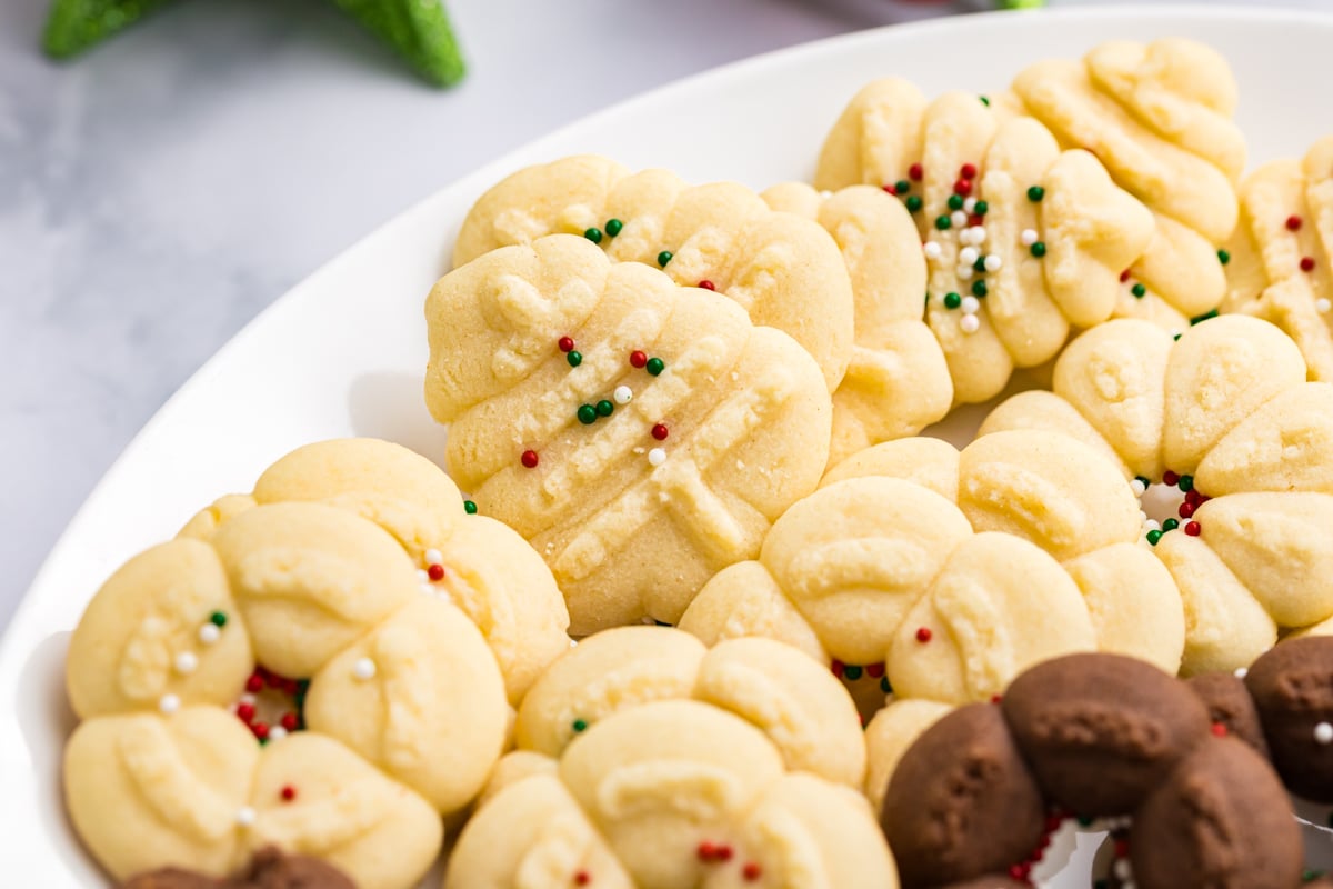 close up angled shot of spritz cookies on plate