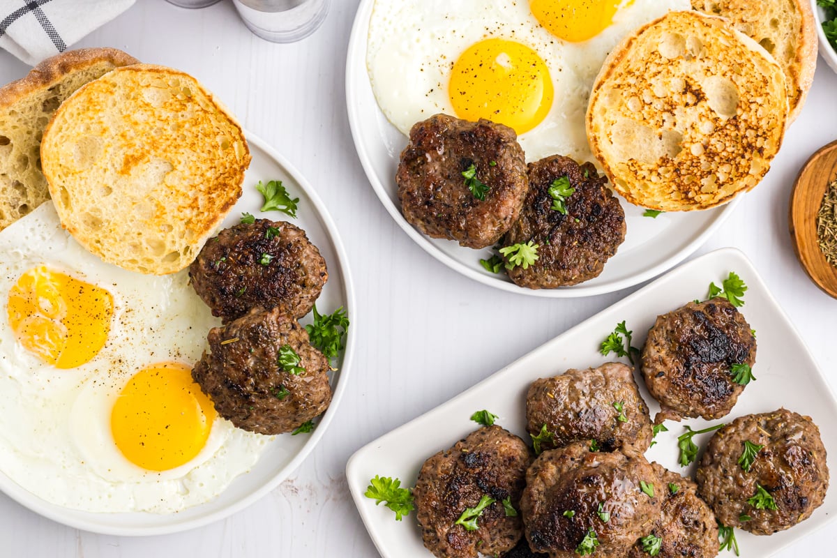 overhead shot of plates of breakfast food like eggs, toast ands sausage