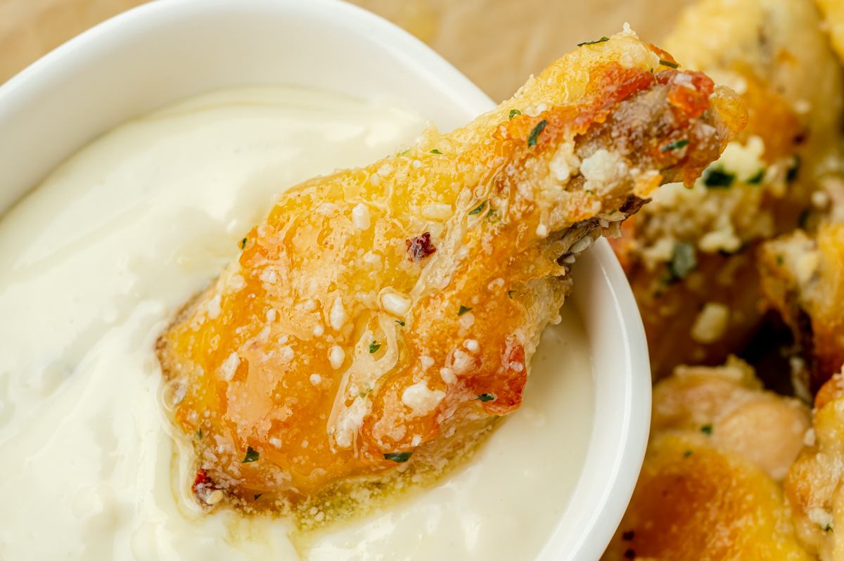 chicken wing dipped in bowl of ranch