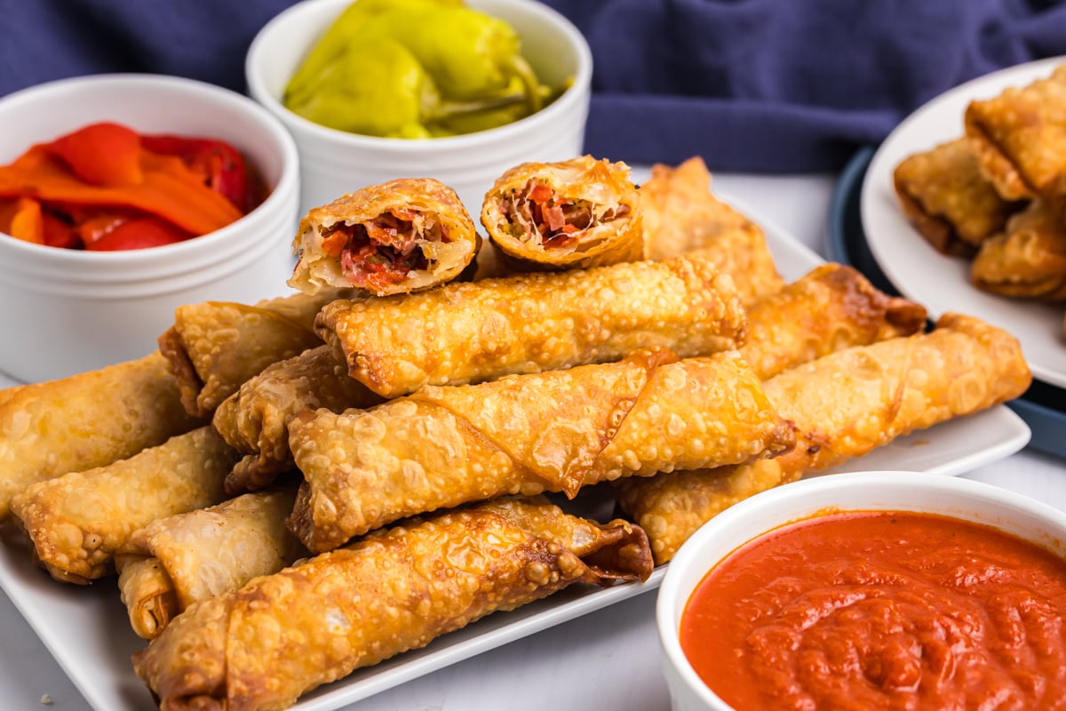 platter of antipasto egg rolls with one broken in half