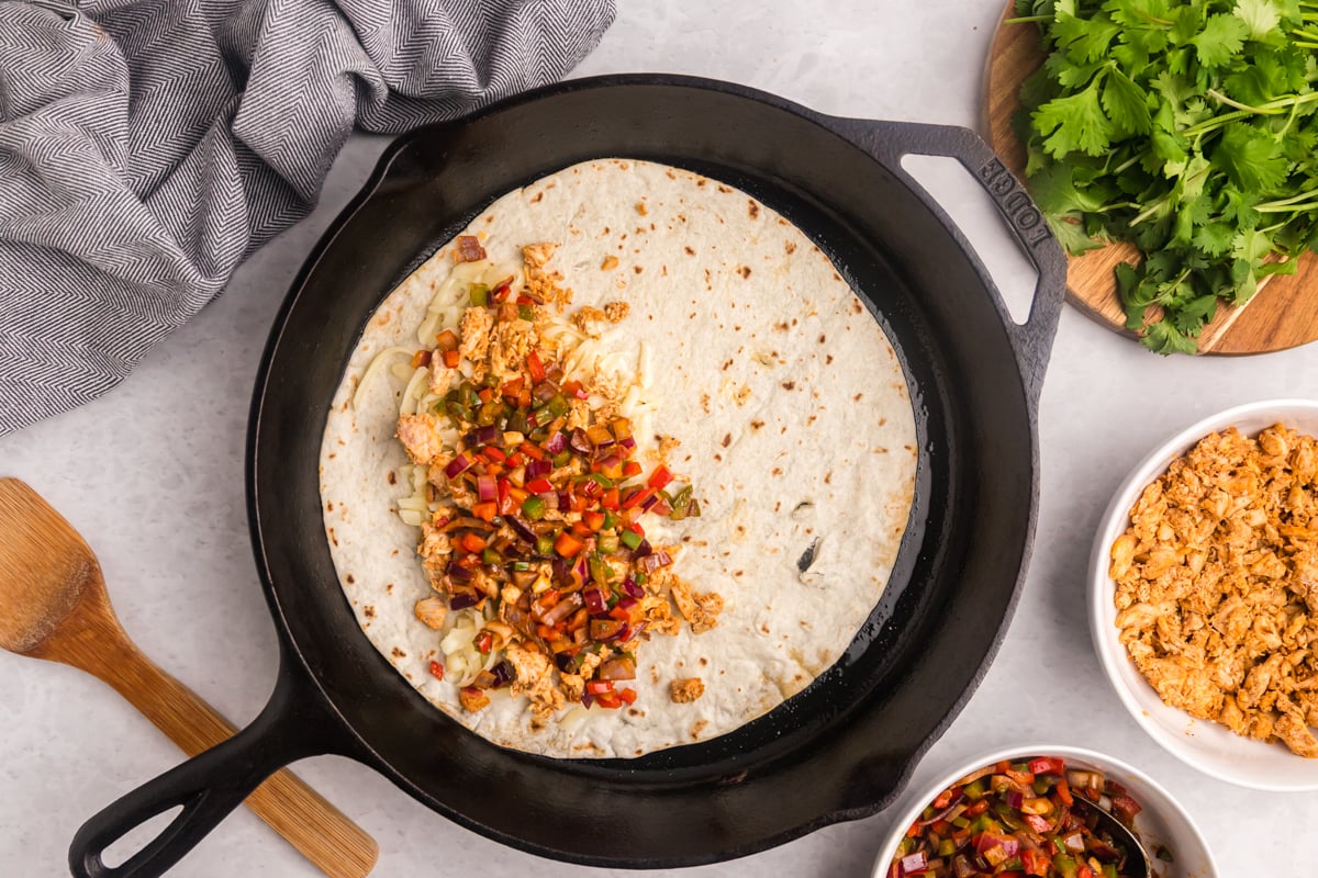 overhead shot of quesadilla cooking in skillet