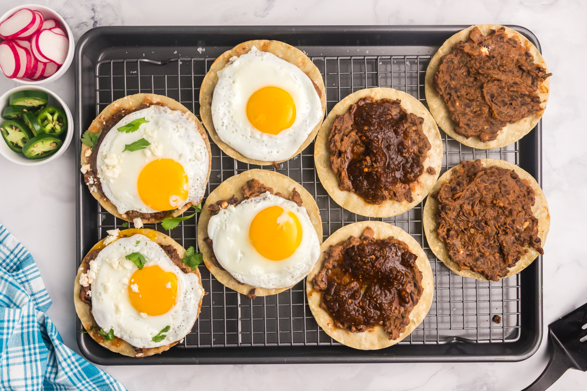 overhead shot of tortillas with black beans and fried eggs