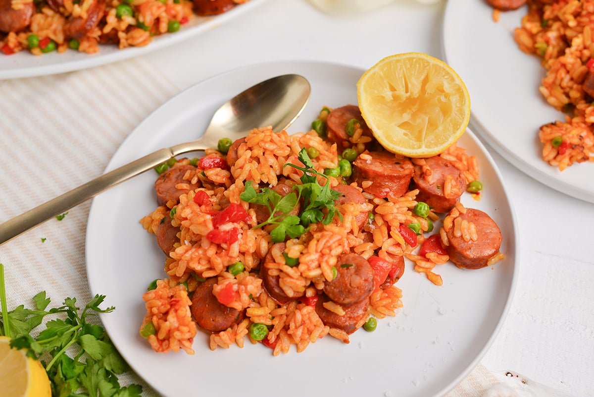 angled shot of paella on plate with lemon