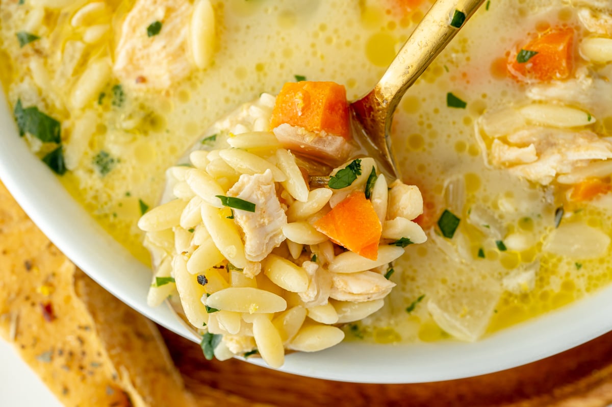 overhead shot of spoon full of lemon chicken soup