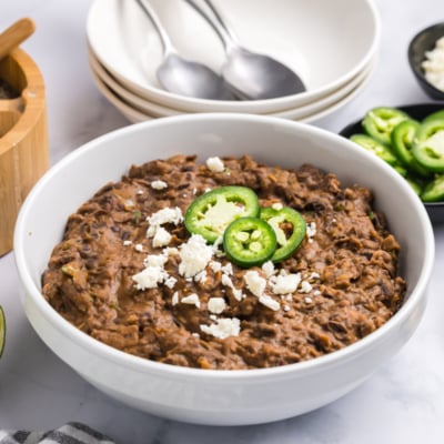 angled shot of bowl of refried black beans